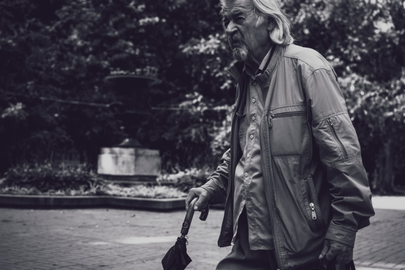 black and white, clothing, 4K, tree, leisure activity, jacket, noir, leather, walking, umbrella, elderly, candid, grey, gray, young adult, old man, outdoors