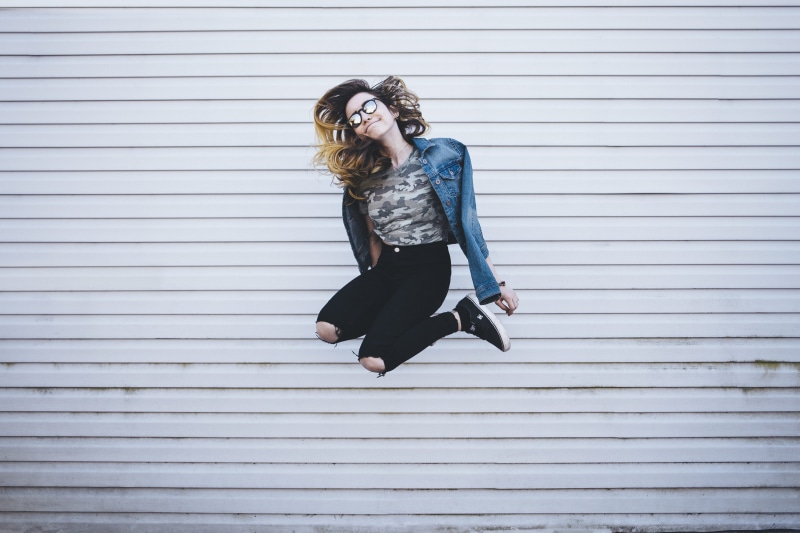 sunglasses, adults only, young women, urban Scene, cheerful, concrete, woman, fashion, casual clothing, full length, real people, jumps, mid-air, one Person