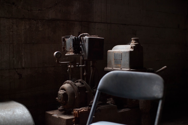 dust, dark, close-up, indoors, shadow, medium group of objects, old machine, behind, grimey, cellar, focus, machine, 5K, metal, fuel and power generation