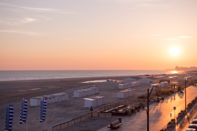high angle view, land, nature, sunset, building exterior, no people, city, orange color, horizon over water, water, sun, beauty in nature, belgium, sky