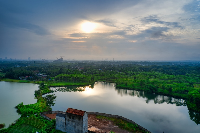 houses, grass, reflections, environment, plant, water, trees, no people, landscape, river, nature, growth, exterior, sight, tranquil scene, lawn, drone shot