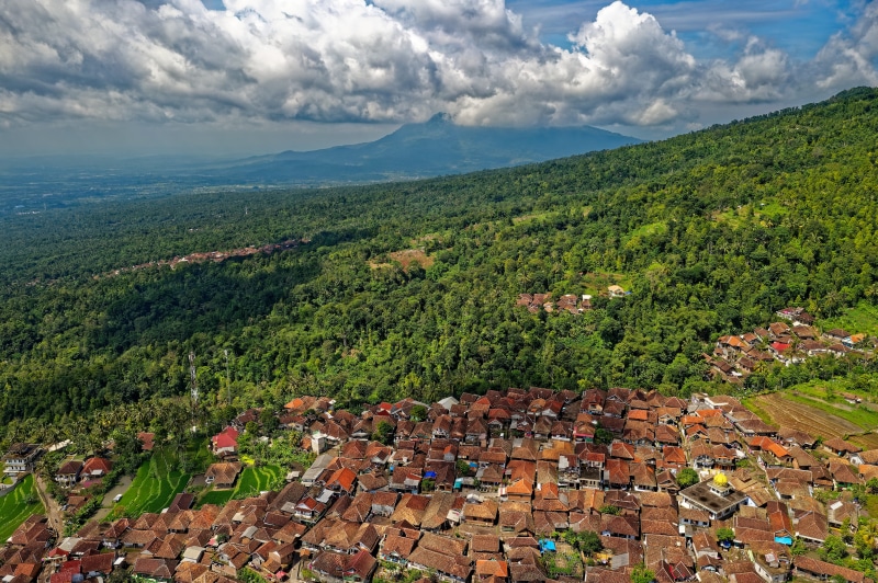 scenery, high angle view, environment, landscape, blue, woods, birds eye view, mountain, photography, built structure, clouds, architecture, aerial, surrounded