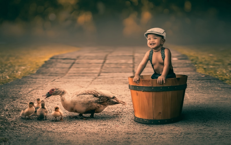 focus on foreground, young, sitting, one person, childhood, outdoors, small, beach, summer, full length, adult, toy, travel, boys, sun, real people, sky