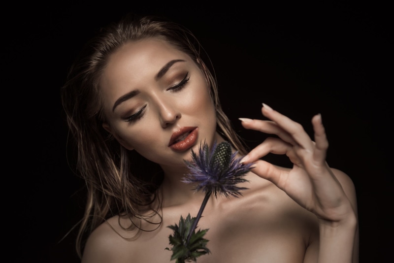 studio shot, model, body part, portrait, adult, one person, fashion, hand, black background, eyes closed, face, beauty, smelling, contemplation, 1080P