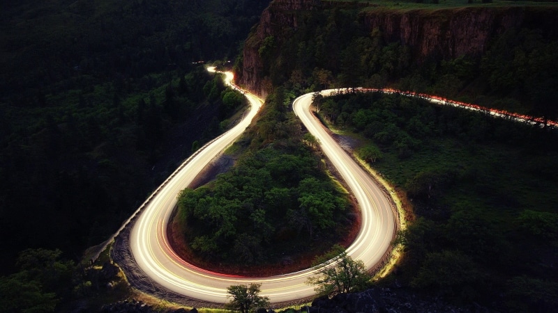hairpin turns, tree, transportation, land, landscape, highway, motion, multiple lane highway, light trail, direction, road, no people, photo, plant, curve