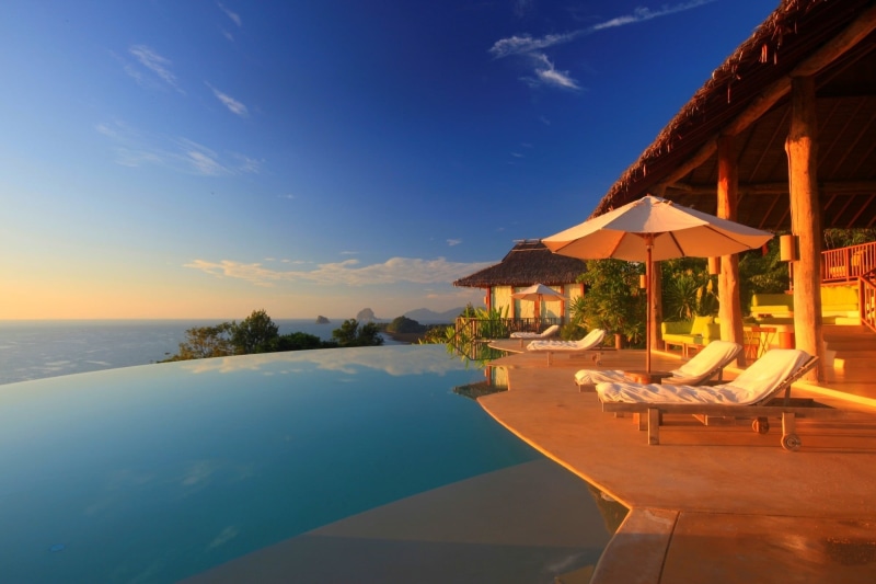 travel destinations, water, tree, infinity pool, nature, tranquility, luxury, pool, sea, tourist resort, beauty in nature, white, blue, parasol, chair