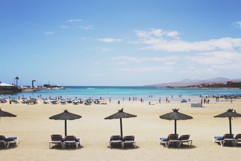 canary islands, beach, chair, land, holiday, horizon over water, sky, incidental people, umbrella, beauty in nature, 5K, spain, day, cloud - sky, caleta de fuste beach