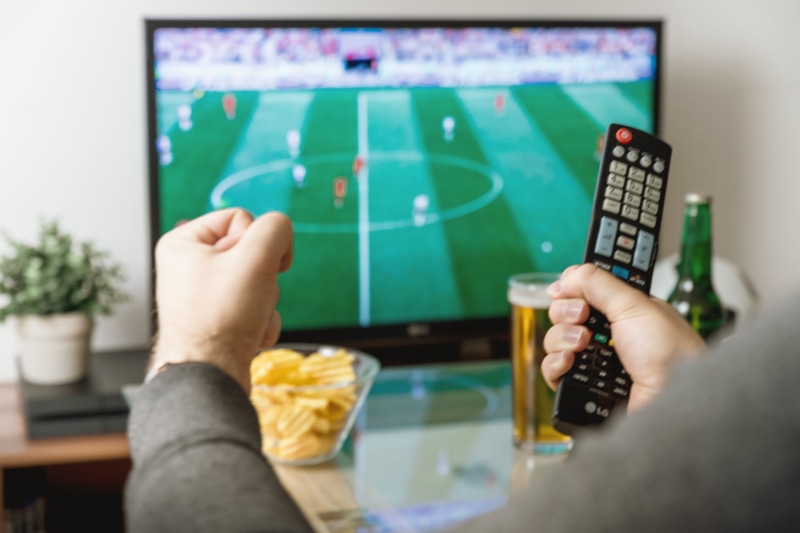 hand, indoors, watching, remote, football, controller, adult, close-up, team sport, sport, television set, leisure activity, relaxation, 5K, domestic room