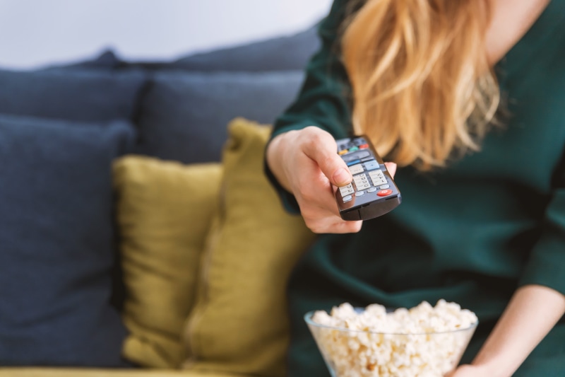 technology, tv, midsection, relaxation, living room, watching, young, home, snack, watching tv, furniture, adult, holding, indoors, casual clothing, women