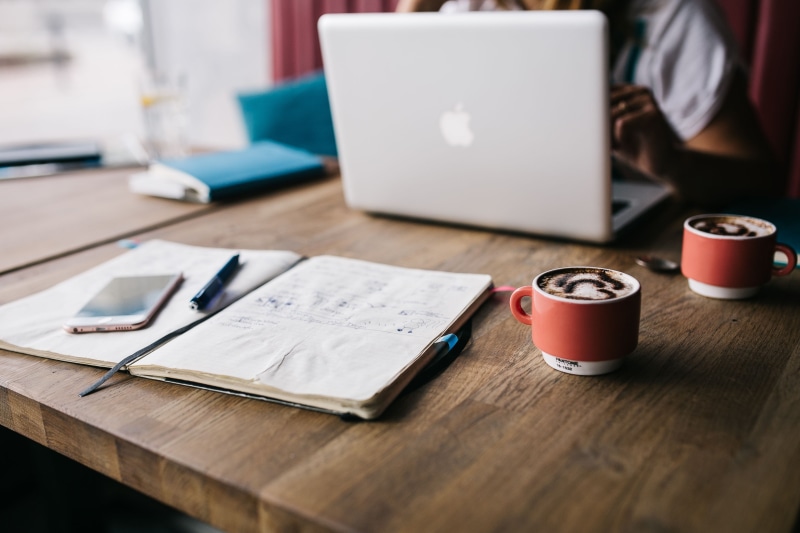 internet, refreshment, workspace, macbook, restaurant, desk, document, female, table, no people, furniture, paper, caucasian, mug, wireless technology