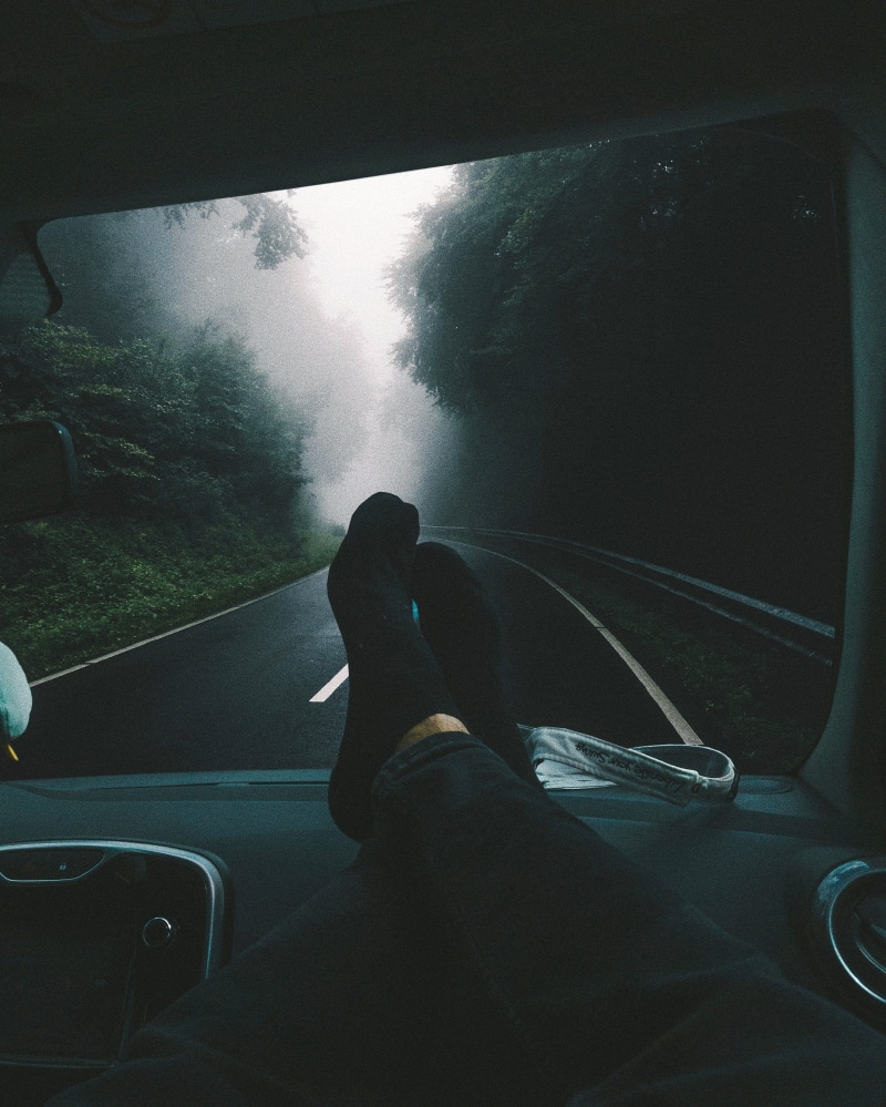windshield, road trip, outdoors, car, glass - material, mode of transportation, real people, body part, window, chill, transparent, leisure activity, trees