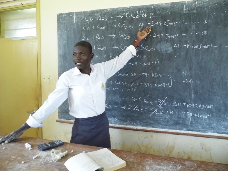 teaching, uganda, copy Space, white dress, board, holding, wearing, one Person, man, 4K, blackboard, mathematics, front view, school, student, white, chemistry