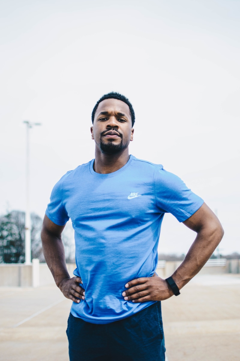 5K, front view, lifestyles, focus on foreground, hand on hip, mens, african Descent, jogging, standing, african american, athlete, s, crew-neck, real people