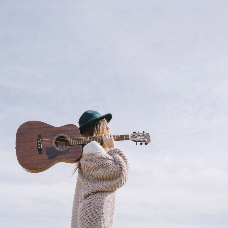 cloud - sky, real people, fashion, one person, acoustic guitar, leisure activity, hairstyle, lifestyles, blue sky, style, string instrument, dreadnought