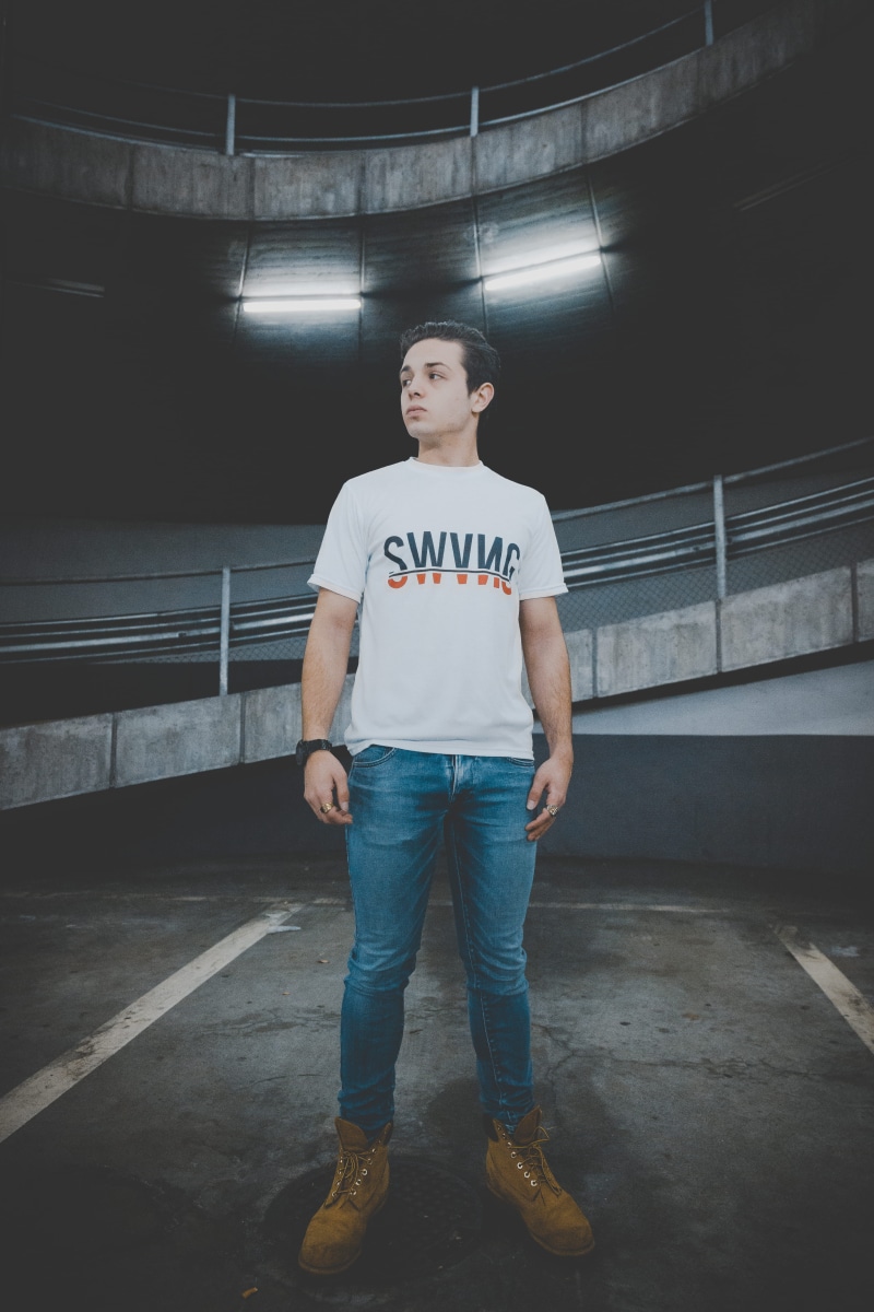 model, wearing, hands in pockets, casual clothing, person, man, shirt, floor, lifestyles, menswear, fashion, real people, black, built structure, trendy