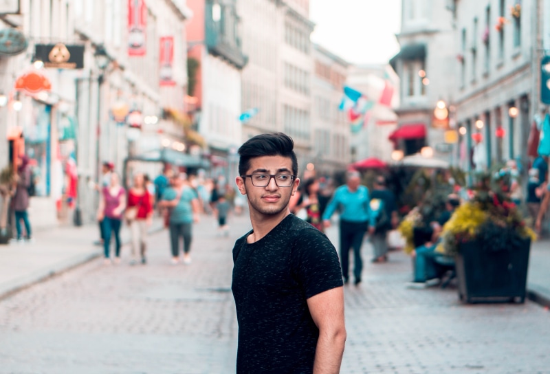 man, wearing, busy, focus on foreground, neck, standing, black shirt, architecture, day, one person, real people, city life, near, shop, silhoutte, city