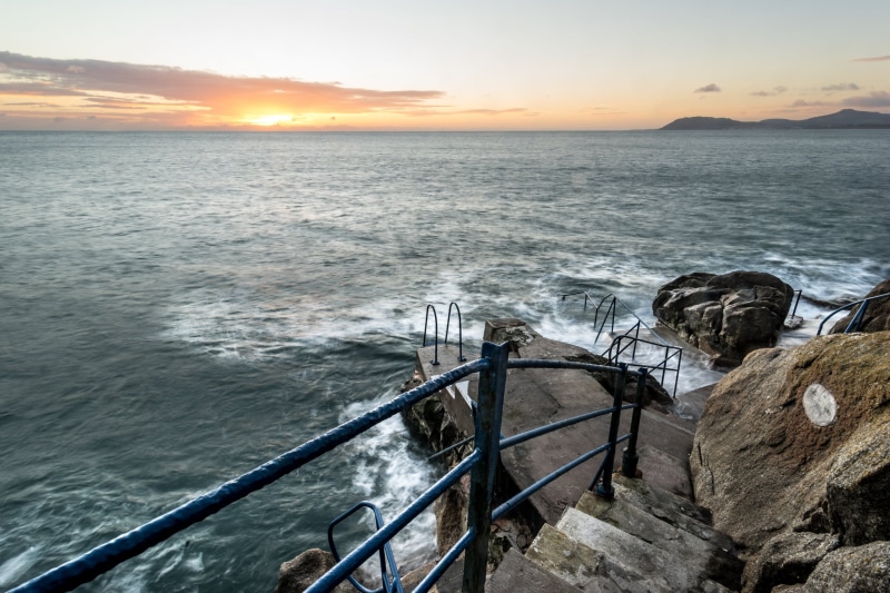 cliff, landscape, clouds, rocks, black, balustrade, black metal, scenics, framed, sky, wave, body of water, across, metal, konica minolta, twilight, Co. Dublin
