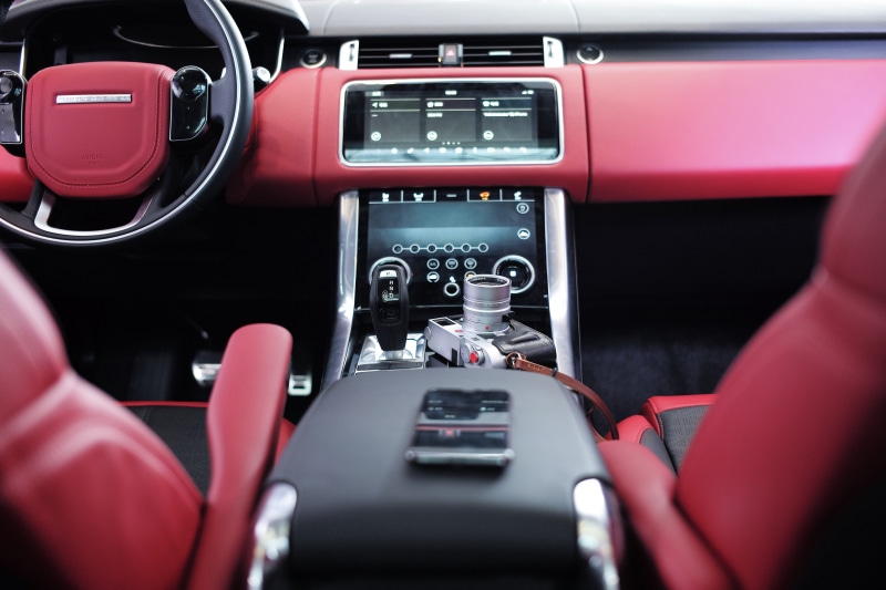 camera, control, vintage, travel, transportation, seats, human hand, black, center, air vehicle, dashboard, cockpit, smartphone, red, land vehicle, leather