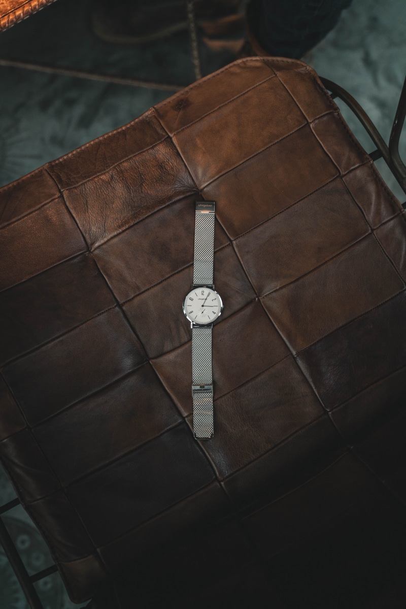 silver, jewelry, arts culture and entertainment, room, minutes, wear, seat, black, style, object, expensive, timer, businessman, day, watch, high angle view