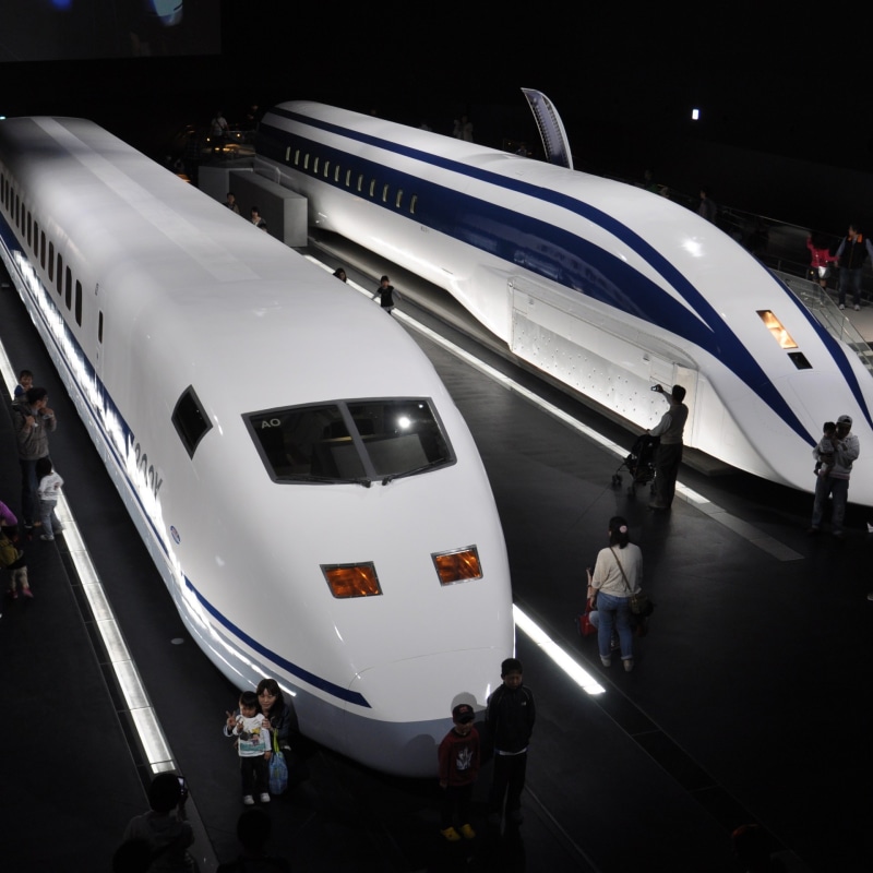 track, transportation, outdoors, standing, passenger, travel, group of people, high angle view, lifestyles, departure, technology, surrounded, trains, destination
