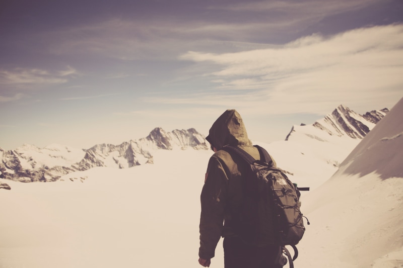 only women, black, outdoors, mountains, standing, coat, walking, adventure, one young woman only, clouds, adults only, field, person, daytime, mountain range