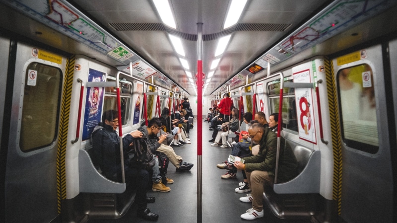 group of people, travel, public transportation, mode of transportation, seat, city life, crowd, real people, commuter, sitting, train, commuter train, people