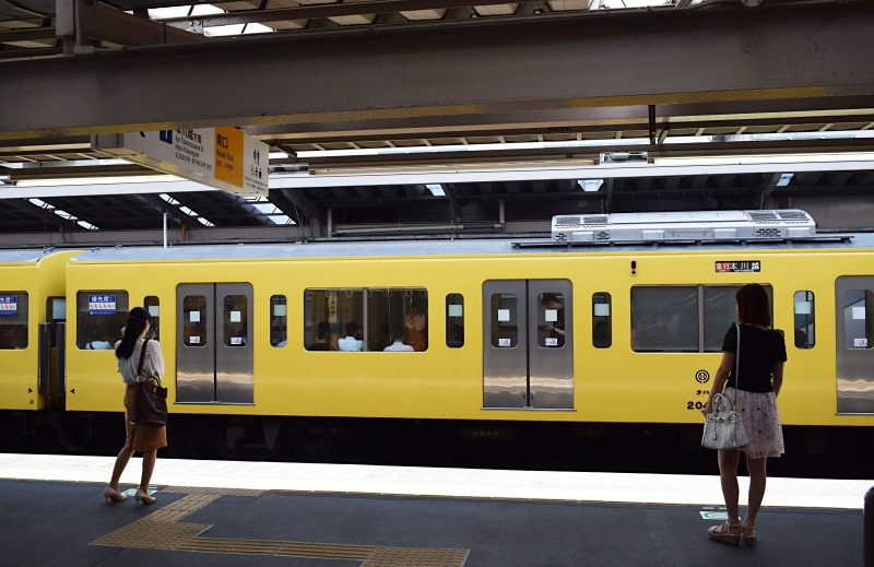 person, terminal, railway, rail transportation, clothing, train - vehicle, business, rail, standing, human, railroad station, outdoors, trains, people