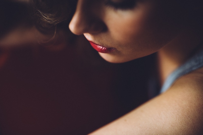 human lips, young women, indoors, contemplation, sad, profile, focus, profile view, woman, nod, beauty, one woman only, black background, human mouth, depression - sadness