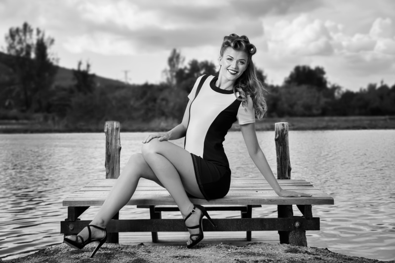 cap, real people, beautiful woman, dress, portrait, hair, hairstyle, women, blonde, girl, water, pin-up, black, lake, 5K, fashion, seat, full length, lifestyles