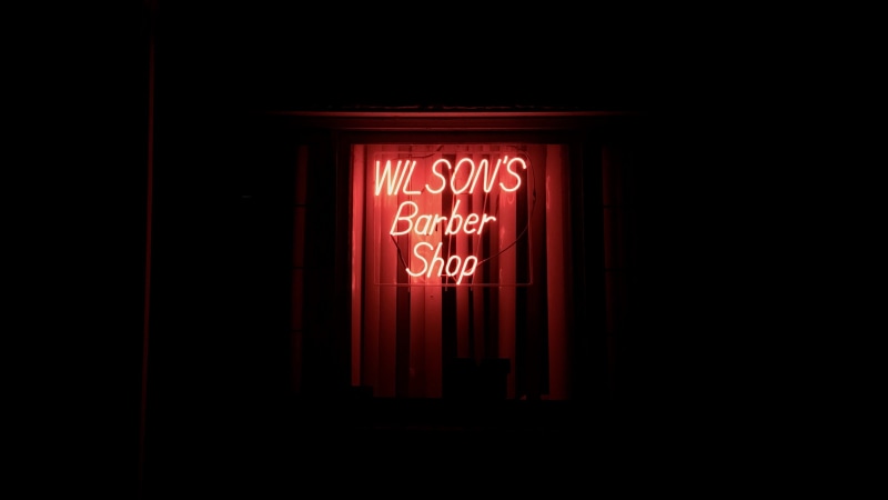 musical instrument, trumpet, western script, communication, barber, road sign, shop, seattle, light, lighting equipment, lightbulb, number, glowing, dark