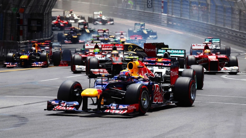 racecar, rc, Red Bull, communication, outdoors, 1080P, motor racing track, transportation, incidental people, built structure, black, competition, motorsport