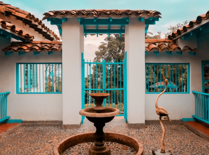 metal, colombia, framed, fountain, pueblito, wall - building feature, teal and orange, built structure, day, building exterior, medellín, statue, art and craft