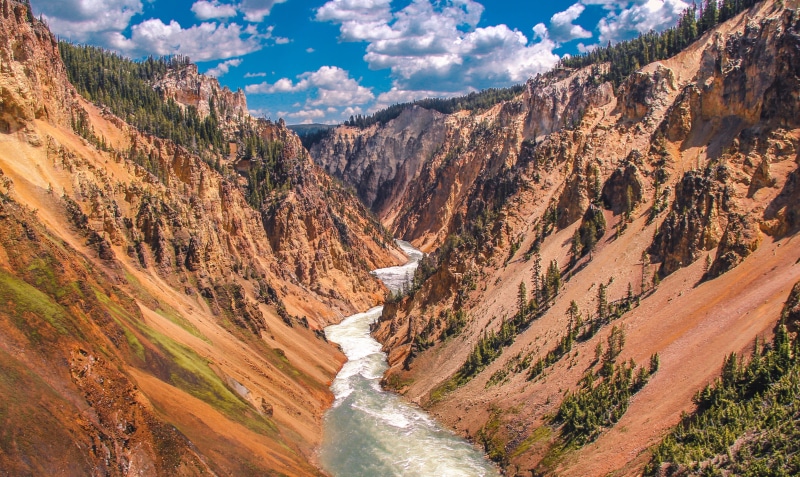 mountain, beauty in nature, water, cloud - sky, river, clouds, no people, orange, sky, rock, flowing, valley, environment, outdoors, plant, canyon, green