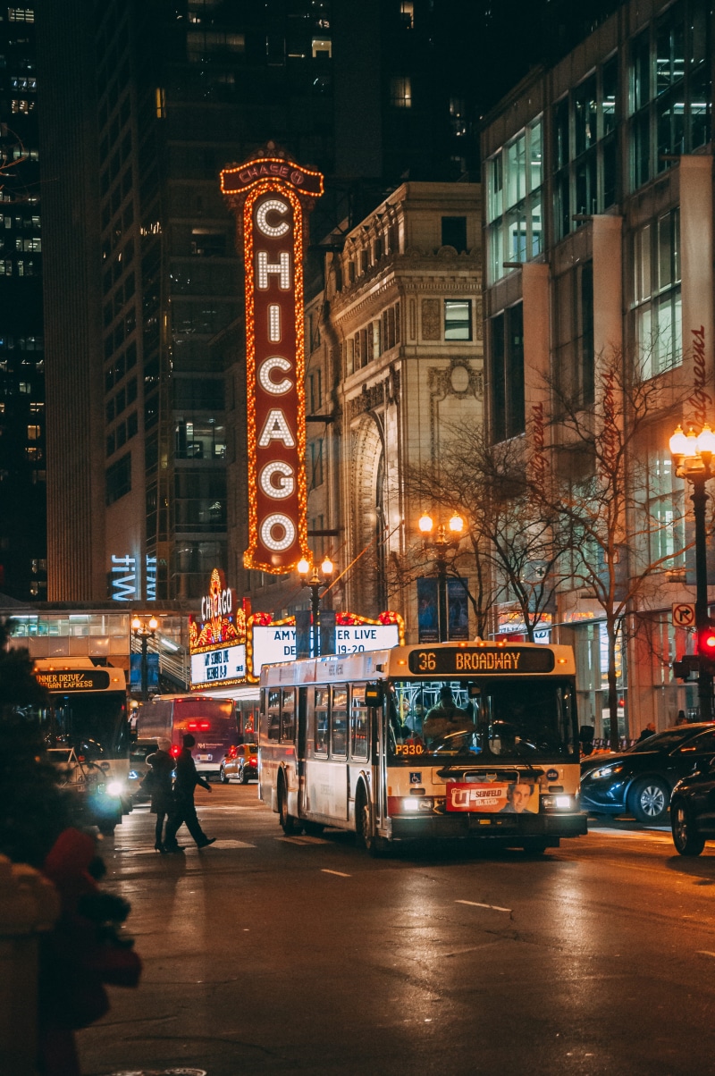 real people, illuminated, outdoors, bus, city life, men, street, red, transportation, city, broadway, neon, mode of transportation, text, led