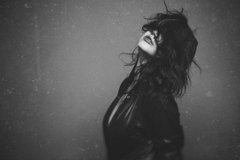 studio shot, waist up, young adult, hair, hairstyle, indoors, side view, real people, human hair, leisure activity, black hair, monochrome, covering face