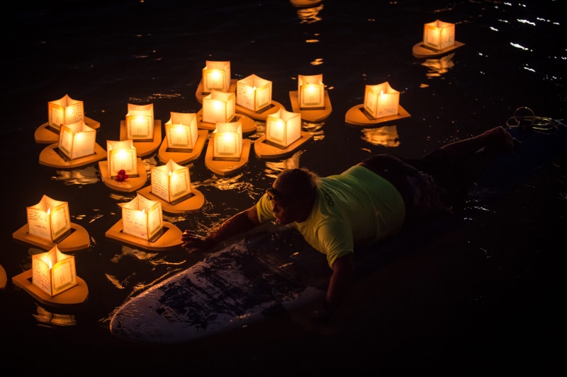 lighting equipment, water, dark, bulb, place of worship, 5K, one person, paper, flame, candles, burning, floating lantern, illuminated, man, body, high angle view