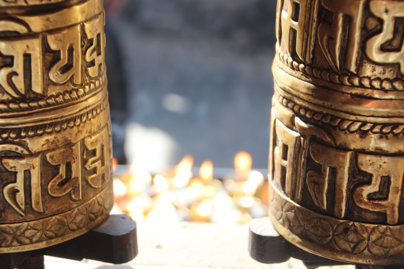 western script, finance, sunlight, container, currency, gold colored, craft, coin, still life, metal, nepal, text, no people, close-up, om mani padme hum