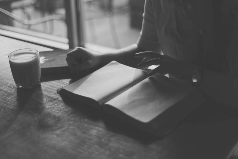morning, drink, business, one person, refreshment, indoors, selective focus, lifestyles, restaurant, human hand, table, hand, reading, book, adult, human body part