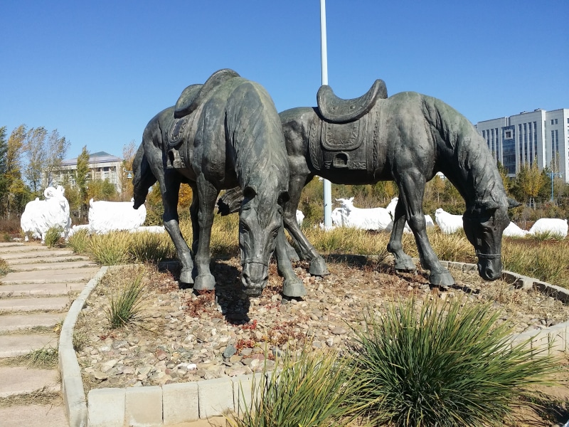 clear sky, statue, outdoors, field, sky, nature, group of animals, representation, plant, tree, jingkiseukan, mammal, art and craft, day, inner mongolia