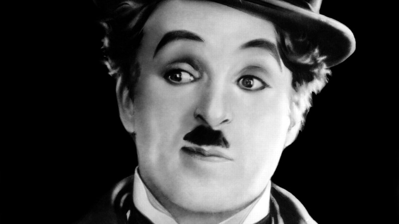monochrome, facial expression, contemplation, emotion, black background, looking, close-up, indoors, teenager, human face, portrait, young men, Charlie Chaplin