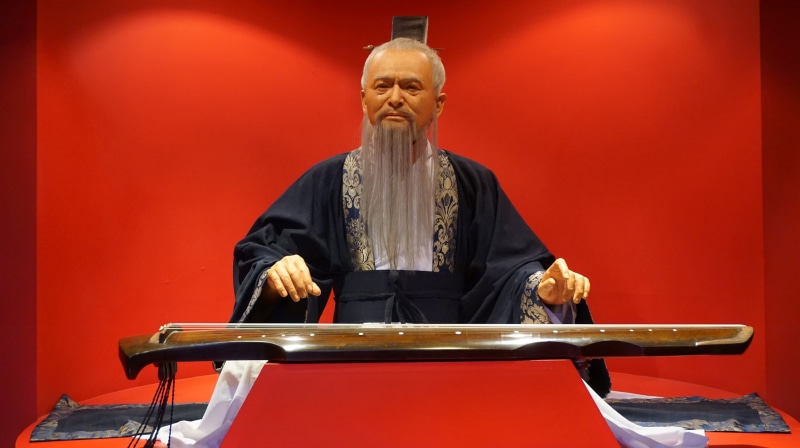 indoors, sitting, one person, skill, musician, confucius, males, senior adult, red, arts culture and entertainment, wax, musical instrument, artist, 2K