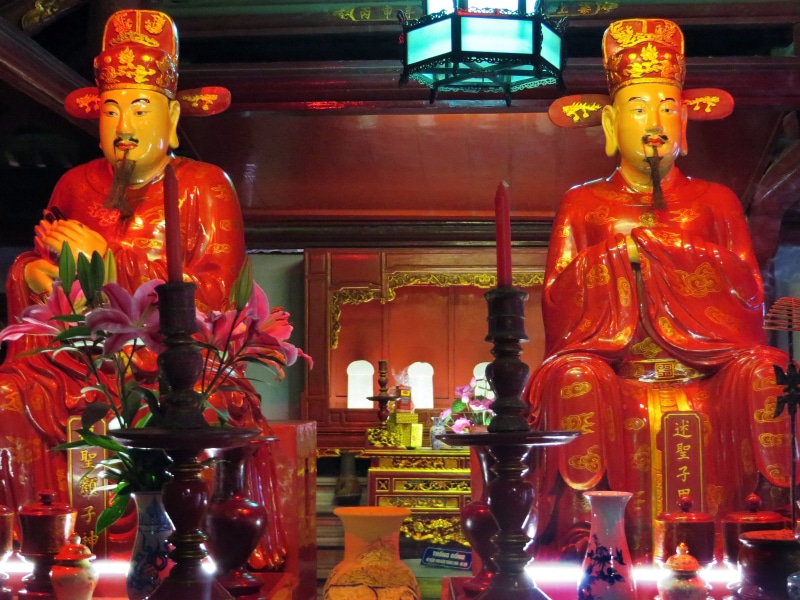 gods, representation, indoors, lighting equipment, built structure, temple, shrine, religion, no people, belief, viet nam, celebration, place of worship