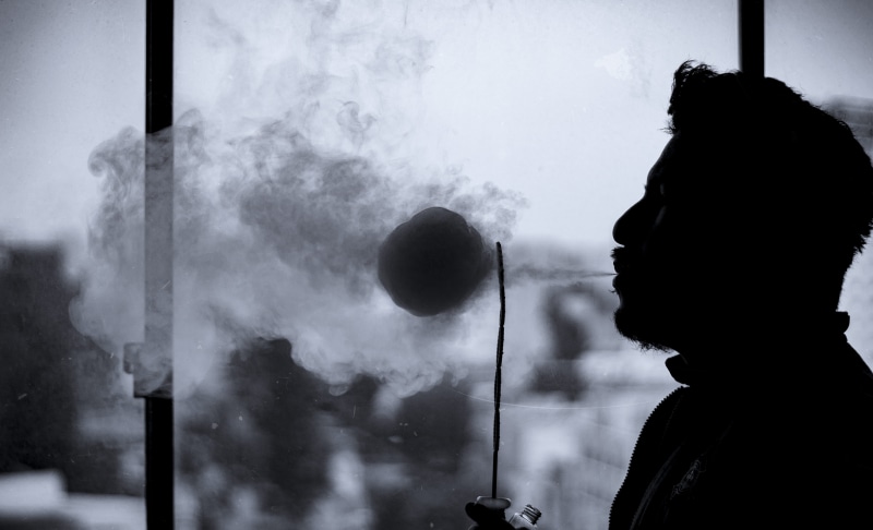 smoke - physical structure, balls, darkest, lima, activity, adult, lights, leisure activity, waist up, indoors, lifestyles, headshot