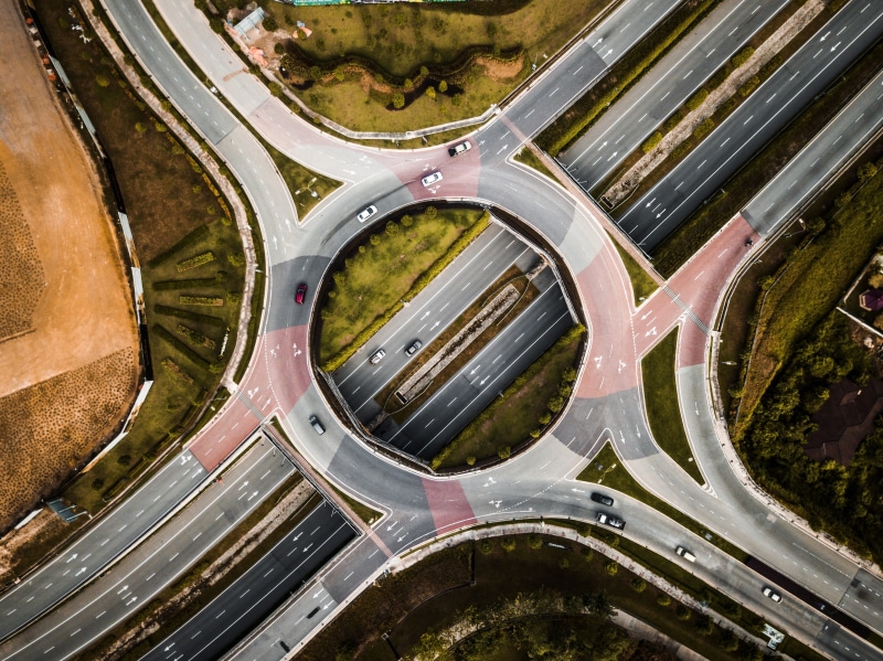 day, intersection, overpass, car, building exterior, roundabout, city, built structure, street, vehicles, vehicle, transportation, aerial view, no people