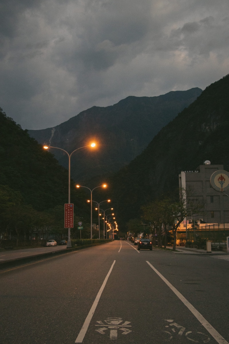 highway, mountain range, lamp post, marking, cloud - sky, way, taiwan hualien, no people, nature, diminishing perspective, 5K, architecture, tarmac, illuminated