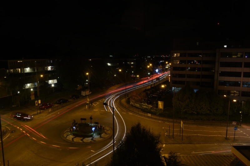 street light, traffic jam, street, building, dark, no people, building exterior, near, time, movement, motion, photography, city life, traffic, city, light trail