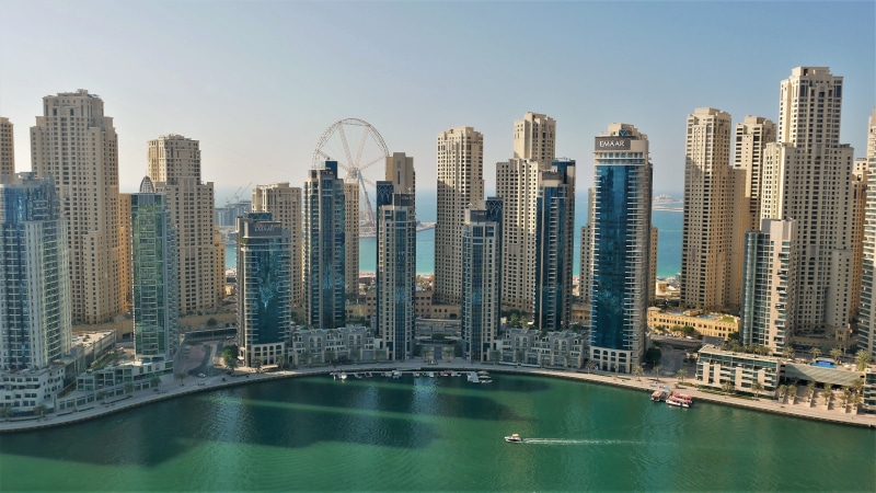 water, tourism, ferris wheel, architecture, office building exterior, journey, sky, bay, financial district, marina, urban skyline, modern, city, outdoors