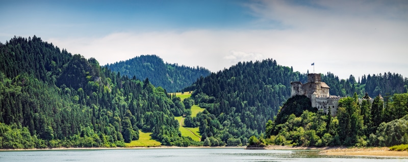 building, tree, lake, vacation, hill, sunlight, fort, scenery, cloud - sky, mountain, tower, landmark, environment, panorama, ancient, scenics - nature