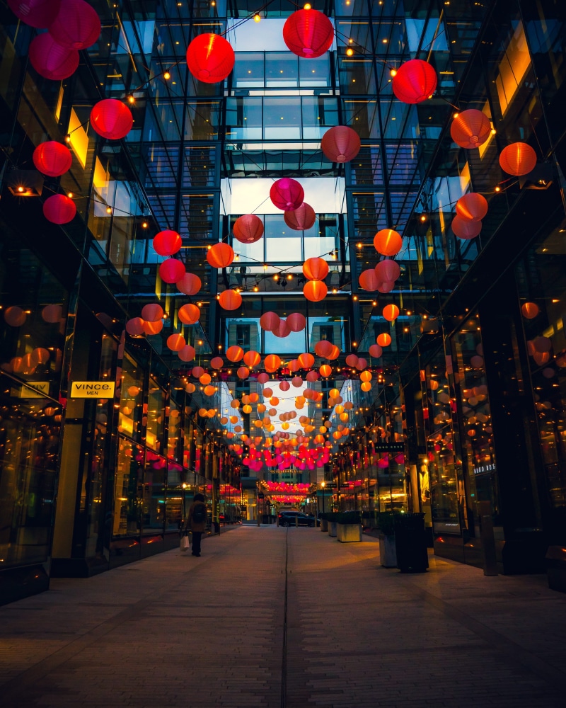 illuminated, person, festival, built structure, led, direction, bazaar, in a row, shop, outdoors, traffic light, arcade game machine, lighting, lampshade