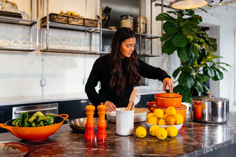 5K, eating, standing, vegetable, salad, cafeteria, le creuset, kitchen, cook, holding, citrus fruit, lifestyles, preparation, restaurant, front view, potted plant